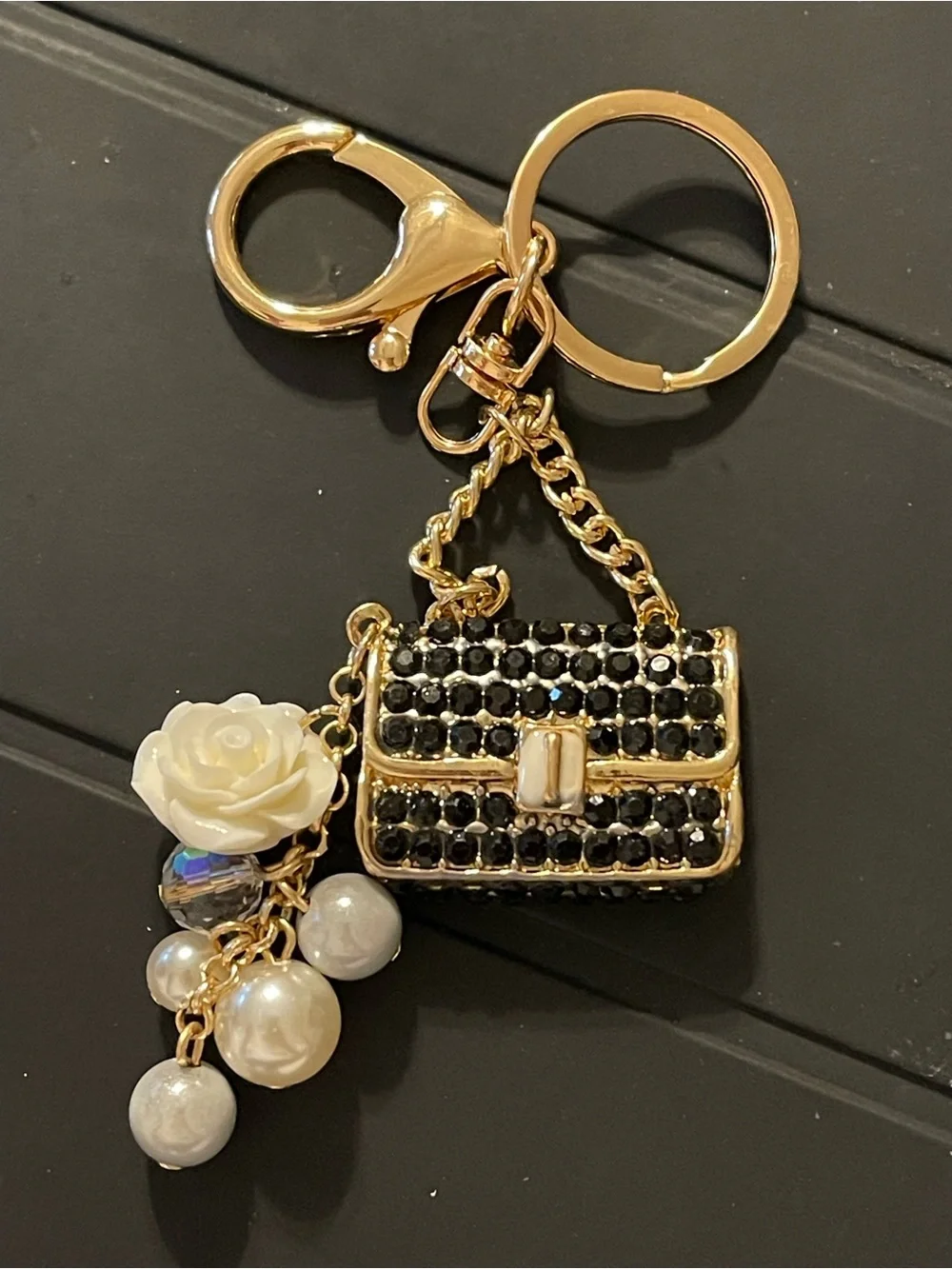 Gold-tone Black Crystal Purse Charm with White Flower and Pearls